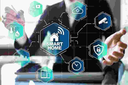 A man is sitting at his desk with smart home icons.