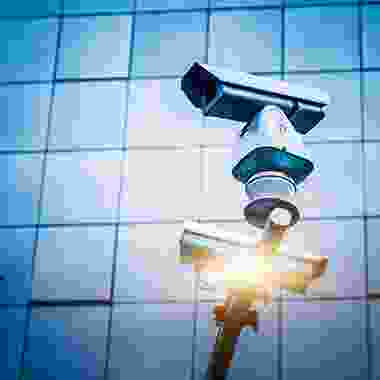 A couple of cameras that are on top of a pole