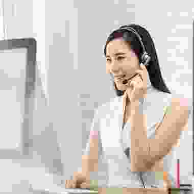 A woman with headphones on talking to someone