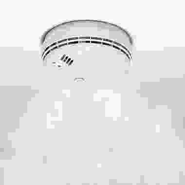 A white smoke detector is shown in the sky.