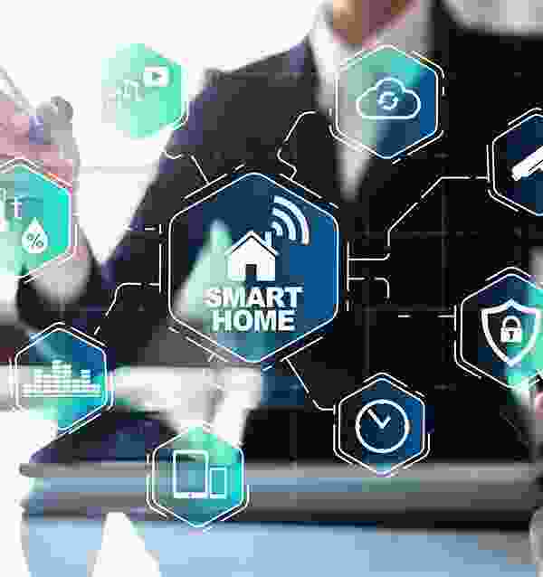 A man is using his laptop to control the smart home.