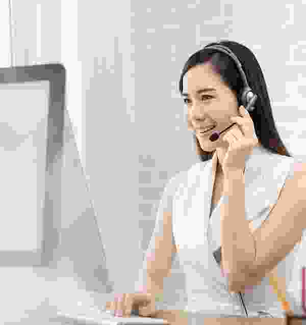 A woman with headphones on talking to someone.