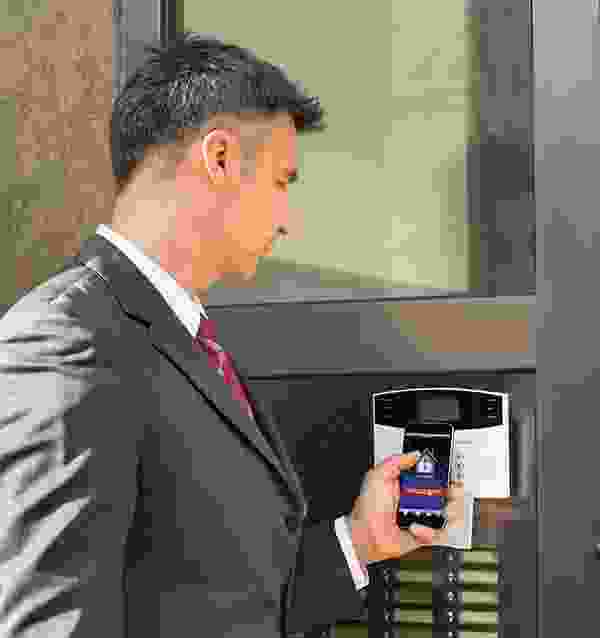 A man in a suit and tie holding a cell phone.