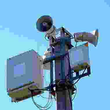 A large camera on top of a pole.