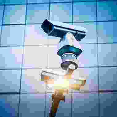 A couple of cameras that are on top of a pole