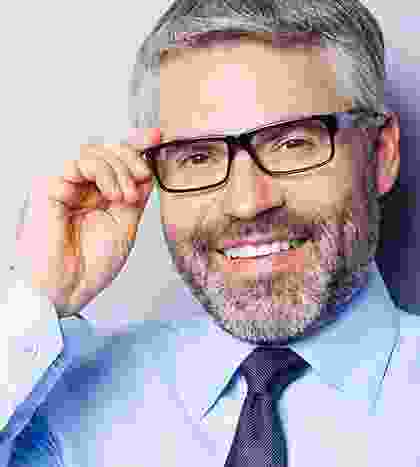 A man with glasses and a beard wearing a blue shirt