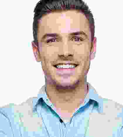 A man with a beard and mustache smiling for the camera.