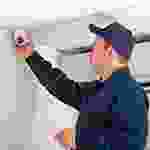 A man in black and blue shirt holding up something.