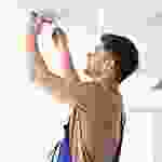 A man holding up his cell phone to take a picture.