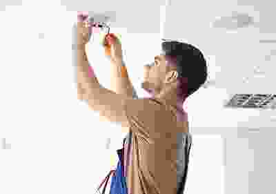 A man holding onto some tools while standing up.