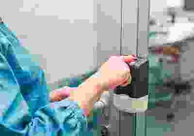 A person is holding on to the door handle.