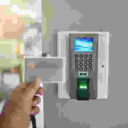 A person is holding the remote control for an electronic device.