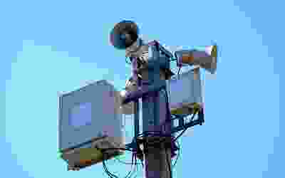 A television antenna on top of a pole.