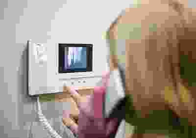 A person holding their hand up to the side of his face.