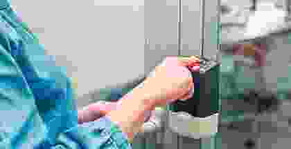 A person is holding their hand over the door.