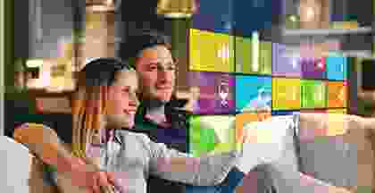 A man and woman sitting in front of a tv.