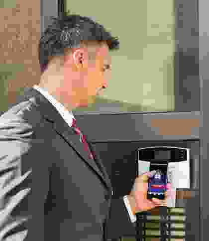 A man in a suit and tie holding a cell phone.