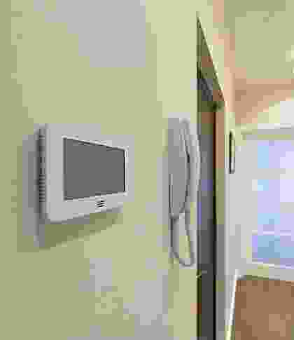 A wall mounted television and phone in a room.