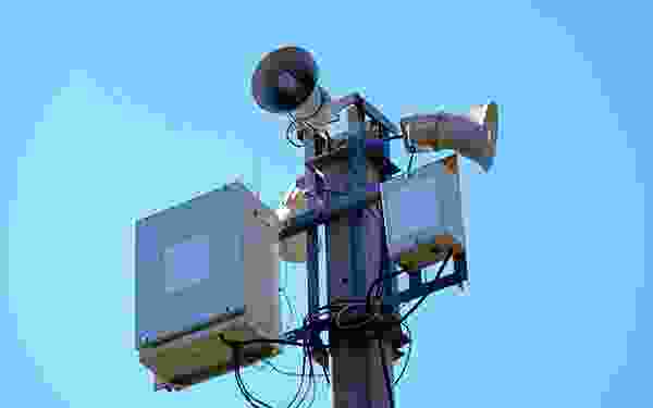 A close up of a camera on top of a pole