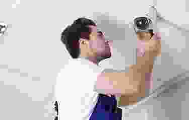 A man holding up a camera to take a picture.