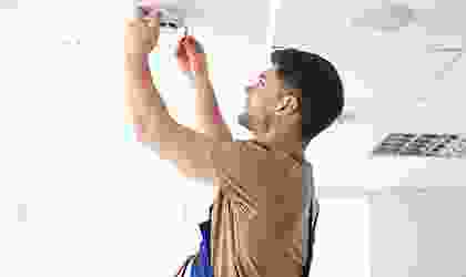 A man holding up a camera to take a picture.