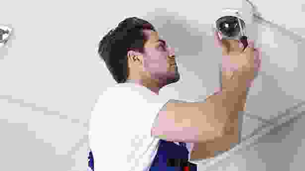 A man holding up a camera to take a picture.