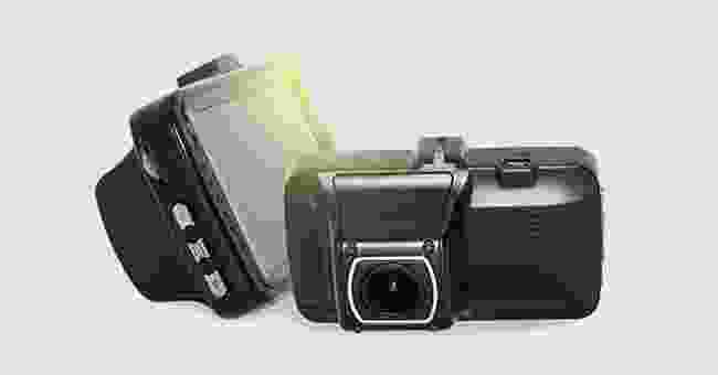 A camera and phone are sitting on the table.