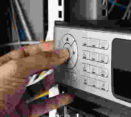 A person is pressing buttons on an electronic device.