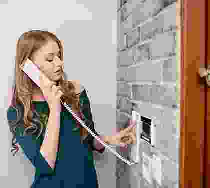 A woman holding onto the phone to her ear