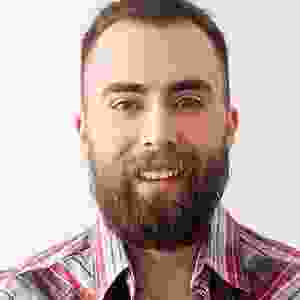 A man with a beard and plaid shirt.