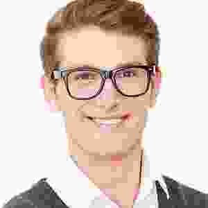 A man with glasses smiling for the camera.