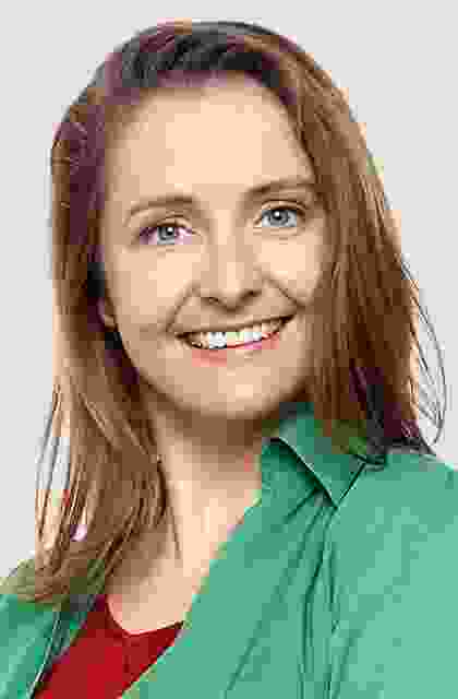 A woman with long hair and a green shirt.