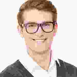 A man with glasses smiling for the camera.