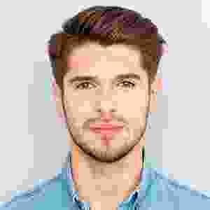 A man with brown hair and blue shirt.