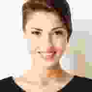 A woman with short hair is smiling for the camera.