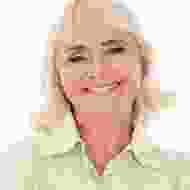 A woman with blonde hair wearing a green shirt.