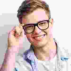 A man with glasses smiling for the camera.