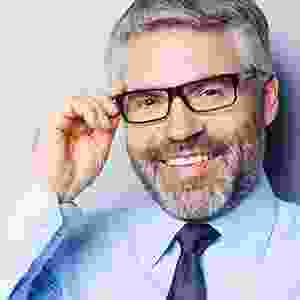 A man with glasses and a beard wearing a tie.