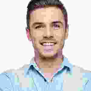 A man with short hair and a blue shirt.