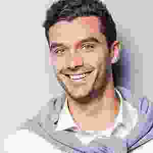 A man with a beard and mustache smiling