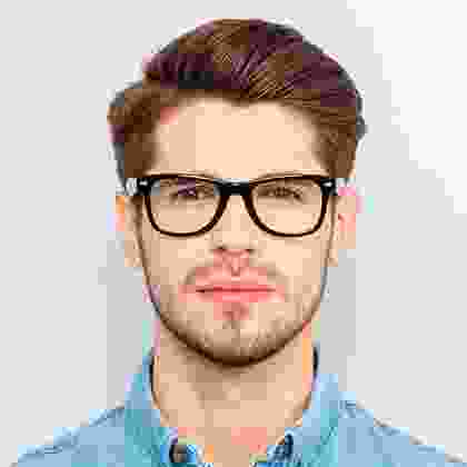 A man with glasses is posing for the camera.