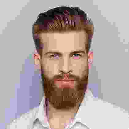 A man with a beard and mustache is wearing white shirt