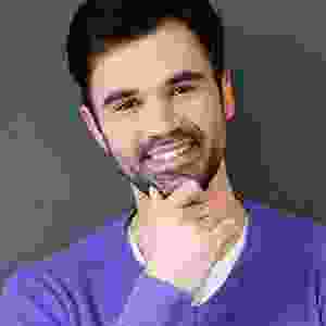 A man with his hand under his chin.