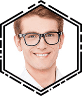 A man with glasses smiling for the camera.