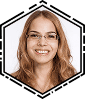 A woman with glasses smiling for the camera.