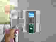 A person is holding their hand up to the side of a wall.